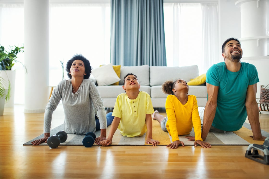 Family exercising yoga at home